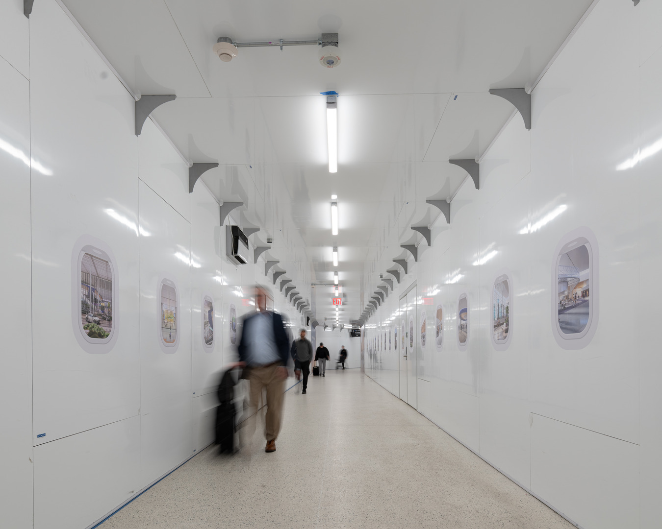 A new pedestrian tunnel takes travelers safely through the jobsite from the SkyWay train to the Terminal B South corridors.