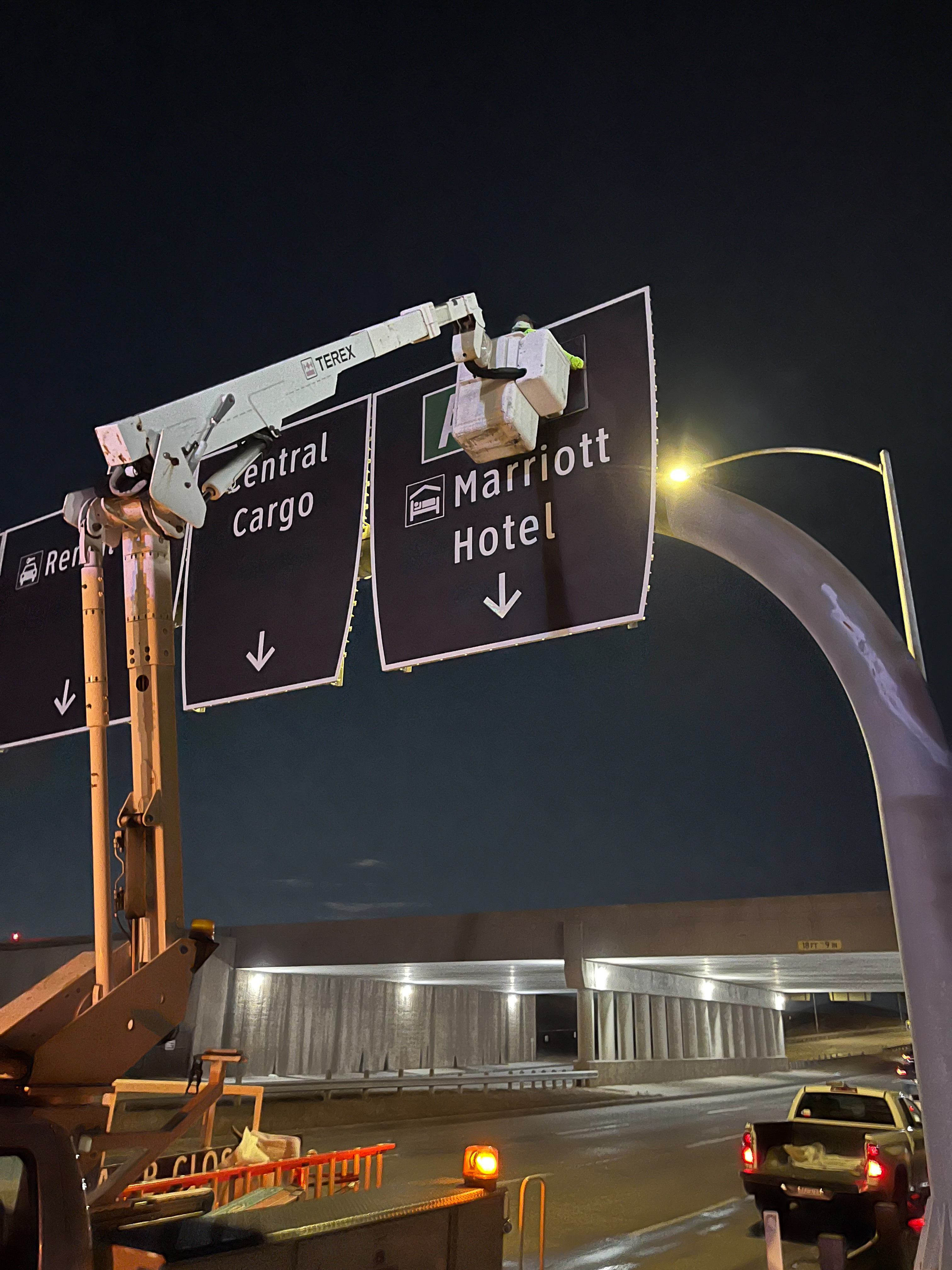 crews change out wayfinding signage