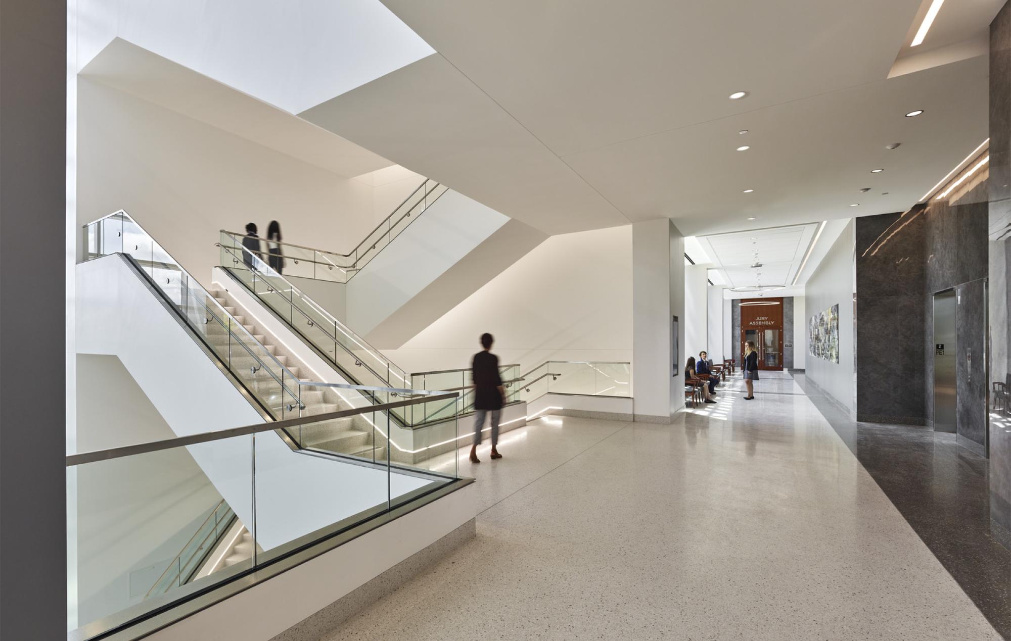 People walk the halls and stairs of the Howard County Courthouse built by Clark Construction