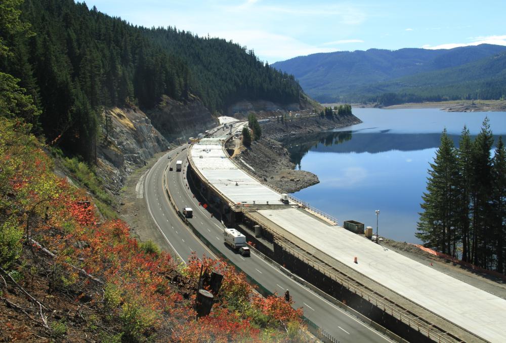 aerial view of I-90 Snowshed along the edge of a wooded hill next to water