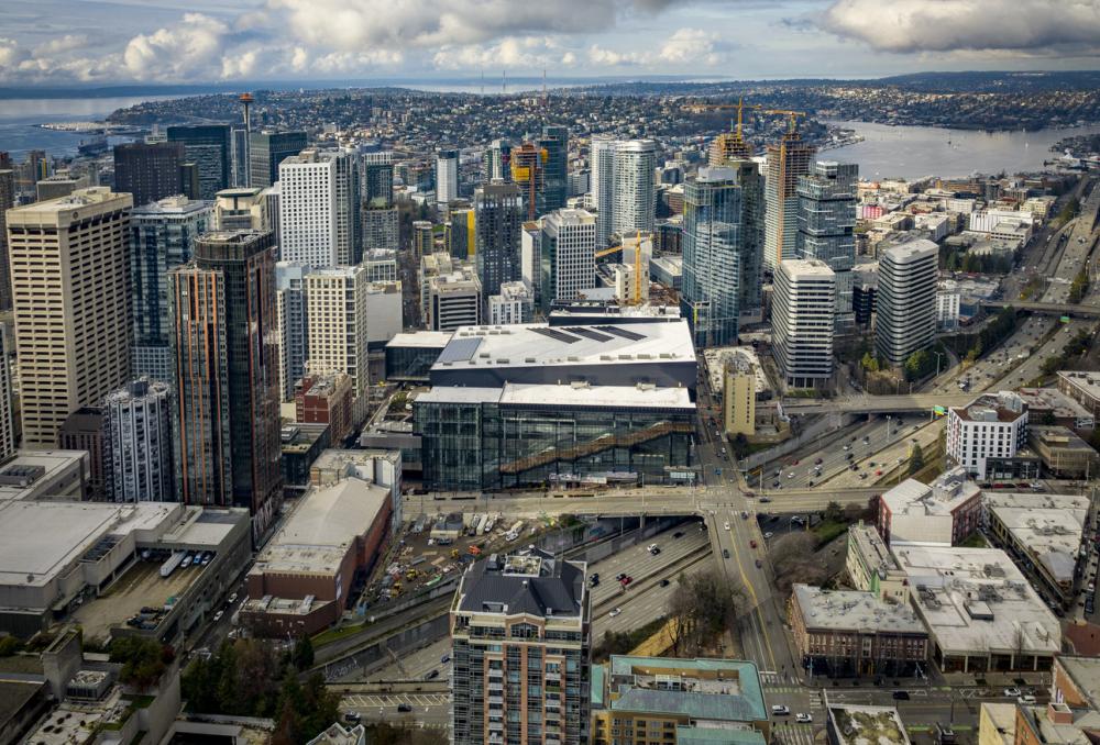 Washington State Convention Center aerial view with the city around it and water behind it