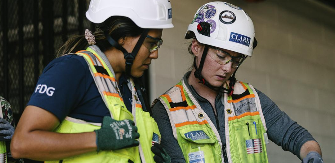 two women working in construction collaborate on a jobsite